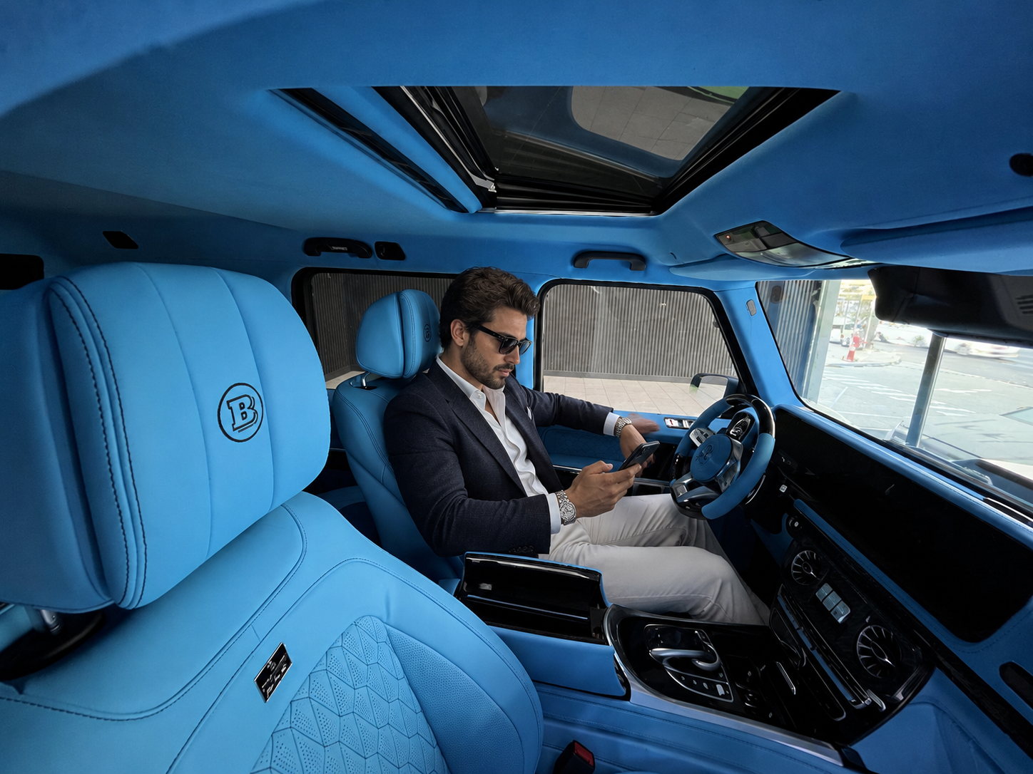 executive in a blue luxury suv